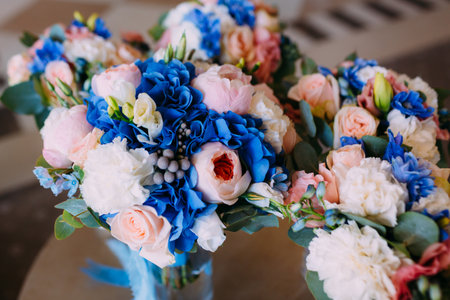 Three Bridal bouquets with creamy roses and peonies and blue hydrangeas. Wedding morning. Close-upの写真素材
