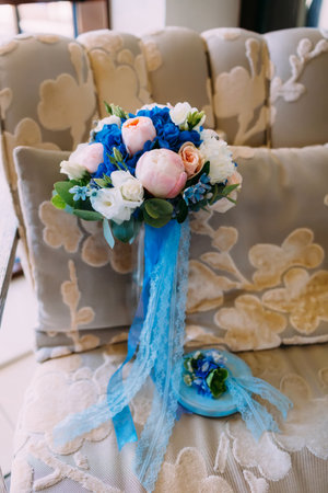 Beautiful bridal bouquet with creamy roses and peonies and blue hydrangeas. Wedding morning. Close-upの写真素材