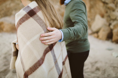 Close up of mans hands touching womans shoulders. Artwork. Selective focus. Rear viewの写真素材