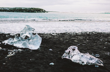 Chunks of Glacier Ice on Black Sand Beach, Iceland. Jokulsarlon seacoast.