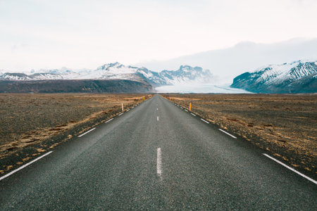 Empty straight road to mountains in Iceland. Copy spaceの写真素材