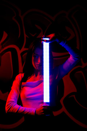 Fashion portrait of young elegant woman. Colored background, studio shot .beautiful neon lightの写真素材