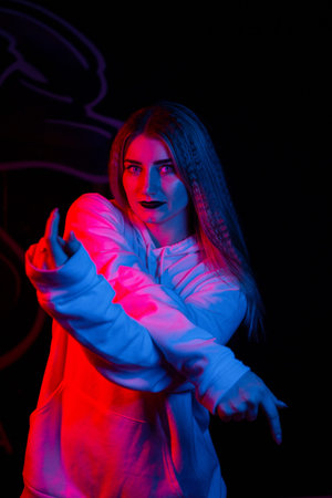 Fashion portrait of young elegant woman. Colored background, studio shot .beautiful neon light