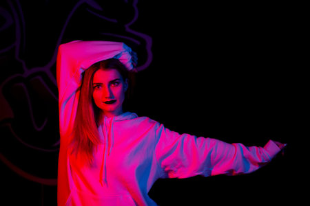 Fashion portrait of young elegant woman. Colored background, studio shot .beautiful neon light