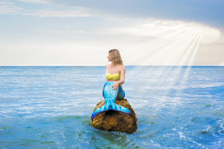 Mermaid is resting on the stone.の写真素材