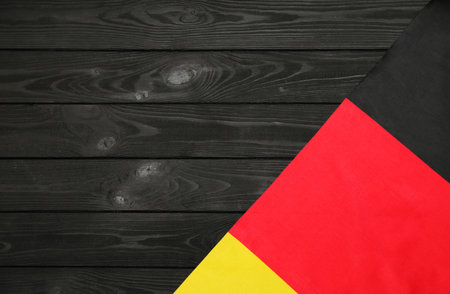 national flag of germany. close-up. German symbol. on a Black wooden backgroundの写真素材