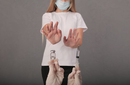 the girl refuses the proposed vaccine. covid. virus. graft.