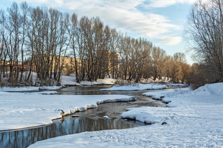 winter landscape of snow-covered fields, trees and river in the early misty morning-bueauty.の写真素材