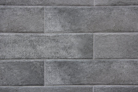 Close-up of gray marble block wall texture background.