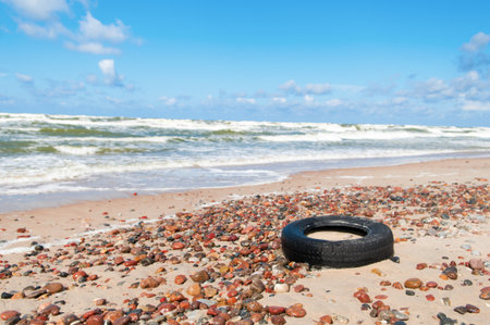 Old tyre beside the seaの写真素材