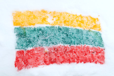 Covered with snow painted on the snow the flag of Lithuaniaの写真素材