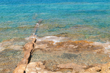 Rocky sea bottom through clear transparent waterの写真素材