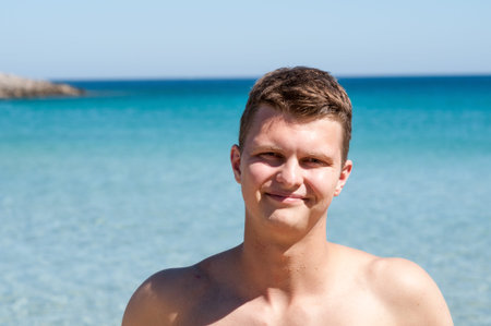 Attractive and happy man smiling on the beachの写真素材