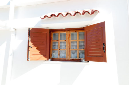 Closed Window with Shutter in Greek Townの写真素材