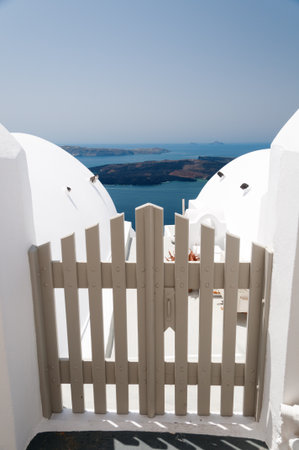 Small gates against volcano caldera and Aegan sea, Santorini Island, Greeceの写真素材