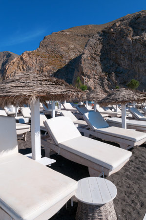Sunbeds on the beach. Santorini island, Greece.の写真素材