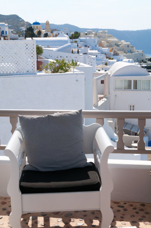 White chair with Santorini island view in backgroundの写真素材