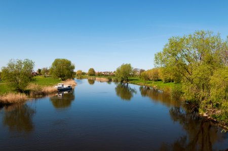 Small river Pakalne reflects blue sky, rusne island, lithuaniaの写真素材