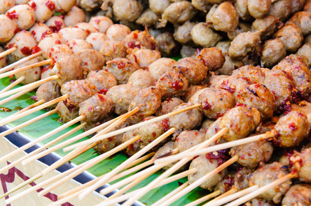 Thai street food close-up with grilled meatballsの写真素材