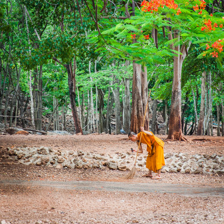Kanchanaburi, Thailand - May 23, 2014:Monk doing daily cleaning routine at at the Tiger Temple in Kanchanaburi, Thailand.Tiger Temple, or Wat Pha Luang Ta Bua, is a Theravada Buddhist temple in western Thailand that was founded in 1994 as a forest temple のeditorial素材