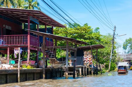Ratchaburi, Thailand - May 24, 2014: Thai locals sell food and souvenirs at famous Damnoen Saduak floating market on  May 24, 2014 in Thailand, in the old traditional way of selling from small boats.のeditorial素材