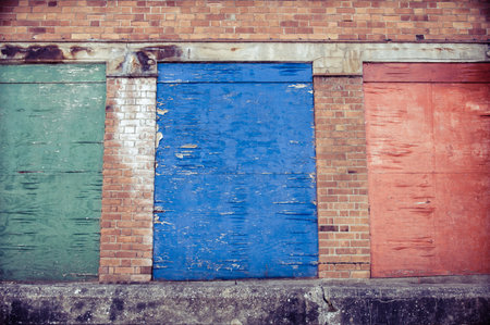 Weathered colored wood planks with peeling paintの写真素材