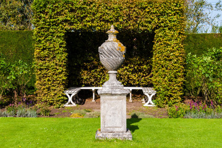 White Wooden garden bench in English gardenの写真素材