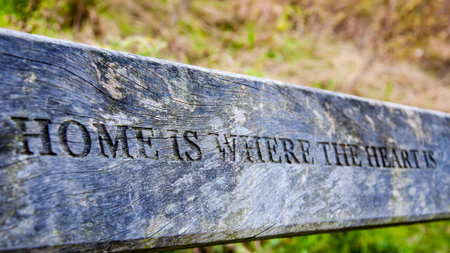 Home is where the heart is inscription carved in wooden boardの写真素材