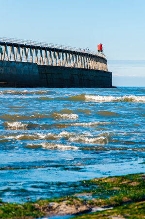 Scenic view of Whitby Pier in sunny autumn day.の写真素材