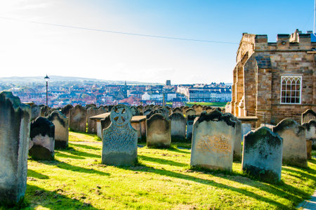 Whitby, North Yorkshire, UK - October 12, 2014: View of St Mary's Church, gravestones and Whitby Abbey in North Yorkshire, UKのeditorial素材