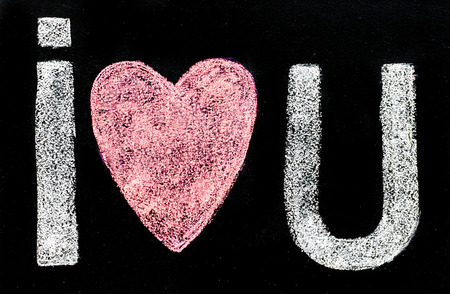 I love you message hand written with chalk on blackboard, word love replaced by heart shape, love conceptの写真素材