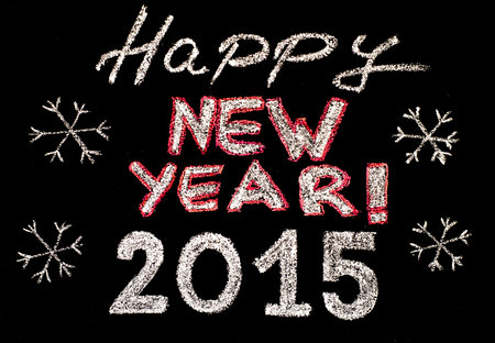 Happy new year 2015, hand writing with chalk on blackboard, isolated on black background, vintage...