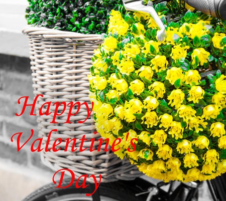 Vintage basket and flowers on bicycle with Happy Valentines Day greeting written with red letters in lower left hand side corner, love conceptの写真素材
