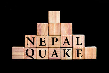 WordS NEPAL QUAKE. Wooden small cubes with letters isolated on black background with copy space available. Concept image.の写真素材