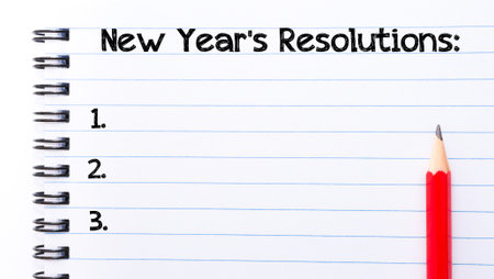 New Year resolutions Text written on notebook page, red pencil on the rightの写真素材