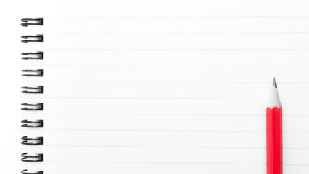 White blank  notebook page with red pencil on the right, with copy space availableの写真素材