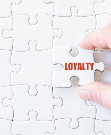 Missing jigsaw puzzle piece with word  LOYALTY. Business concept image for completing the puzzle.