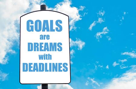 Goals Are Dreams with Deadlines  motivational quote written on white road sign isolated over clear blue sky background. Concept  image with available copy spaceの写真素材