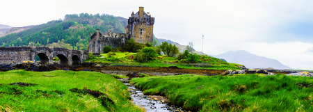 Panoramic view of famous Eilean Donan Castle in Scotland, UK. Situated on a small isle at the meeting point of three sea lochs - Loch Long, Loch Duich and Loch Alsh, is one of the most iconic images of Scotland.のeditorial素材