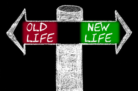Opposite arrows with Old Life versus New Life.
Hand drawing with chalk on blackboard. Choice conceptual imageの写真素材