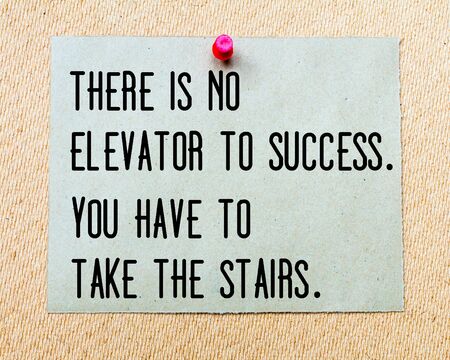 There is no Elevator To Success, You Have to Take The Stairs written on paper note pinned with red thumbtack on wooden board. Business conceptual Imageの写真素材