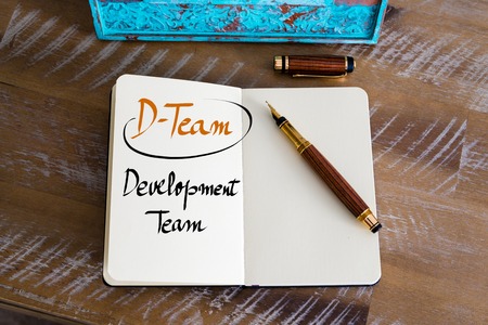 Retro effect and toned image of a fountain pen on a notebook. Business Acronym D-TEAM as Development Team as business concept imageの写真素材