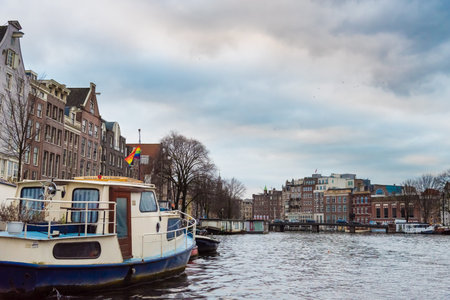 Amsterdam, Netherlands - January 9, 2017: Street view with traditional Dutch row houses and famous canals in Amsterdam historical city center, the Netherlands' capital, known for its artistic heritageのeditorial素材