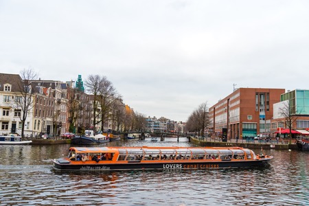 Amsterdam, Netherlands - January 9, 2017: Street view with traditional Dutch row houses and famous canals in Amsterdam historical city center, the Netherlands' capital, known for its artistic heritageのeditorial素材