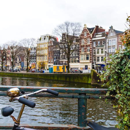 Amsterdam, Netherlands - January 9, 2017: Street view with traditional Dutch row houses and famous canals in Amsterdam historical city center, the Netherlands' capital, known for its artistic heritageのeditorial素材