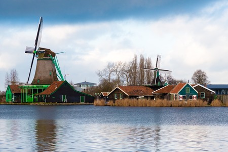 Zaanse Schans, Netherlands - January 10, 2017: Rural Dutch scenery with water canals in Zaanse Schans village known for well-preserved historic windmills and row houses near Amsterdam, Netherlands.のeditorial素材