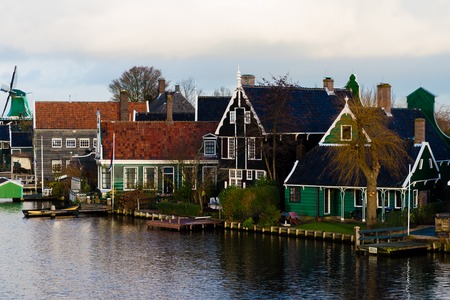 Zaanse Schans, Netherlands - January 10, 2017: Rural Dutch scenery with water canals in Zaanse Schans village known for well-preserved historic windmills and row houses near Amsterdam, Netherlands.のeditorial素材