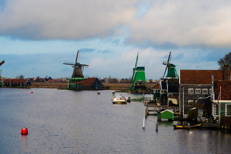 Zaanse Schans, Netherlands - January 10, 2017: Rural Dutch scenery with water canals in Zaanse Schans village known for well-preserved historic windmills and row houses near Amsterdam, Netherlands.のeditorial素材
