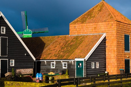 Zaanse Schans, Netherlands - January 10, 2017: Rural Dutch scenery with water canals in Zaanse Schans village known for well-preserved historic windmills and row houses near Amsterdam, Netherlands.のeditorial素材