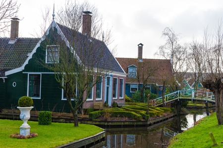 Zaanse Schans, Netherlands - January 10, 2017: Rural Dutch scenery with water canals in Zaanse Schans village known for well-preserved historic windmills and row houses near Amsterdam, Netherlands.のeditorial素材